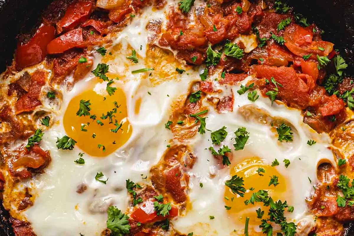 Juicy tomato and egg shakshuka in a skillet.