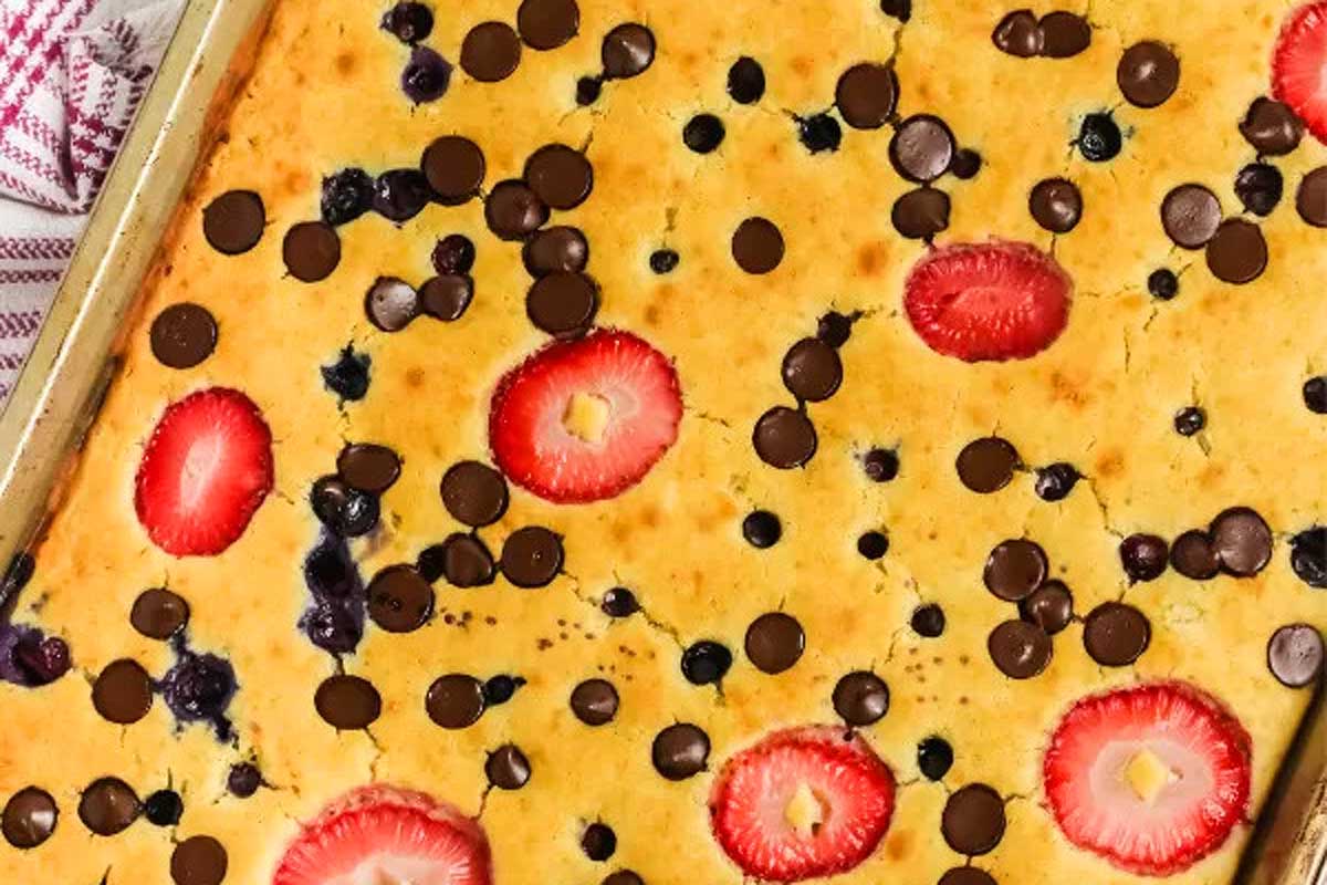 A blueberry chocolate chip cookie with strawberries and chocolate chips.