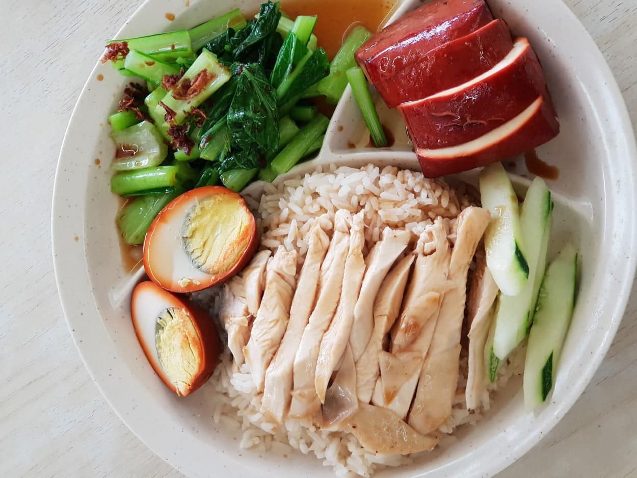 Singapore’s Hainanese Chicken Rice on a white plate.