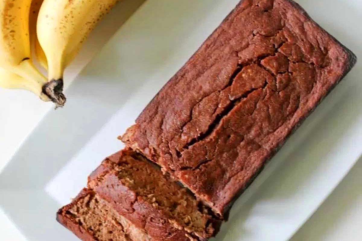 A slice of chocolate banana bread on a white plate.