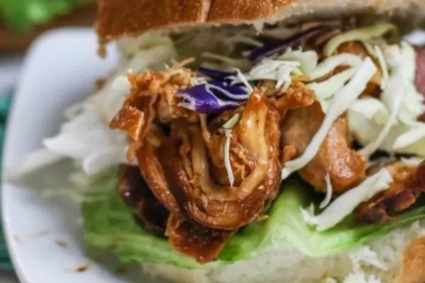 Slow cooker bbq chicken in a sandwich.