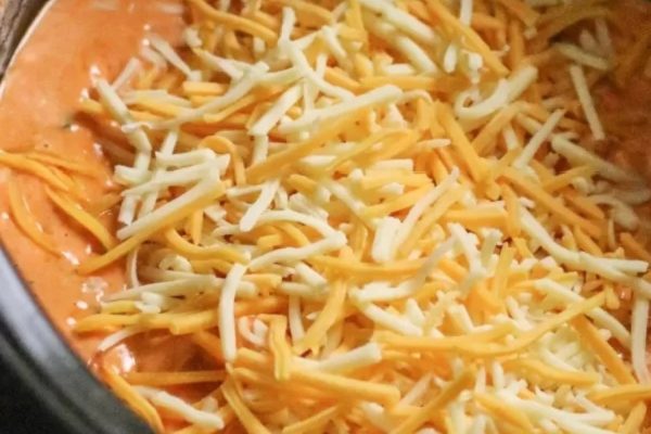 A crock pot full of cheesy nachos.