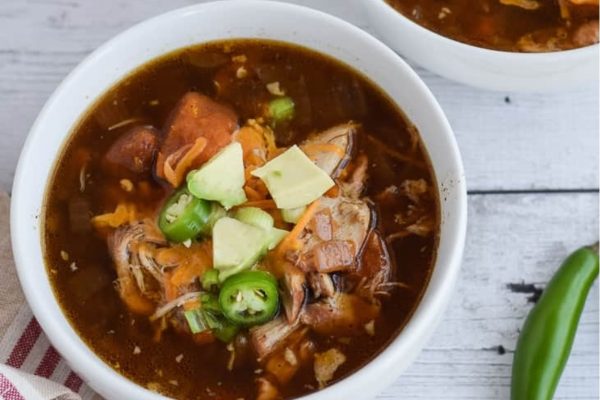 Slow cooker Mexican chicken soup in a white bowl.