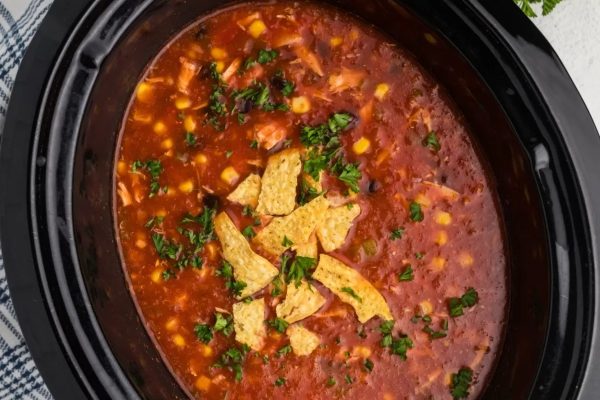 Slow cooker pot with chicken soup.