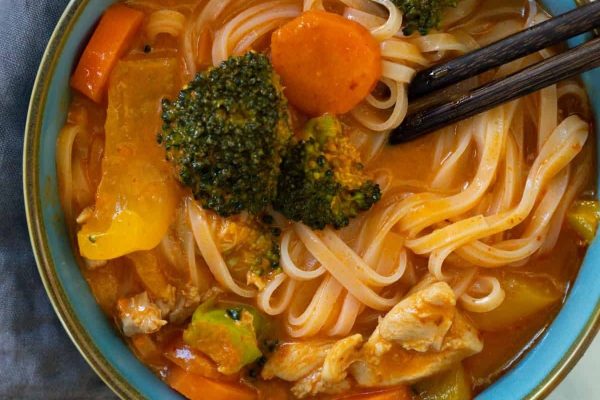 Spicy Chicken Noodle Soup in a small bowl with chopsticks.