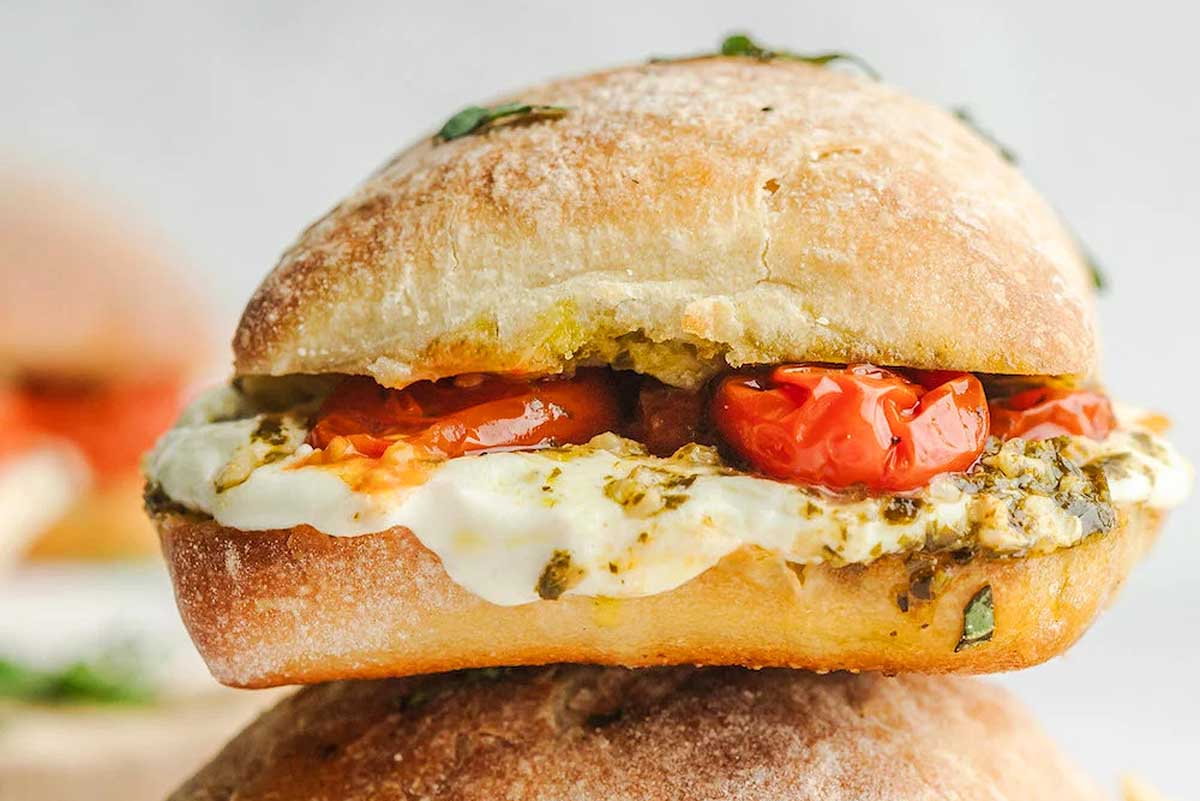 Tomato and mozzarella panini on a plate.