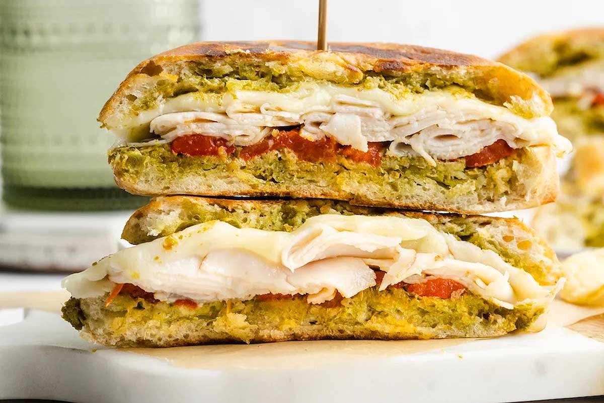 Crispy hot turkey and pesto panini on a plate.