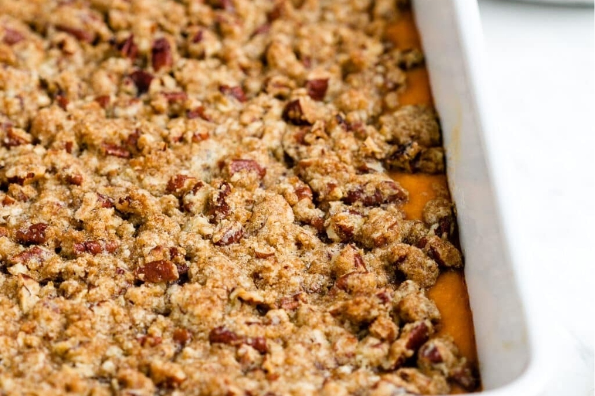 Sweet potato casserole recipe in a white baking dish.