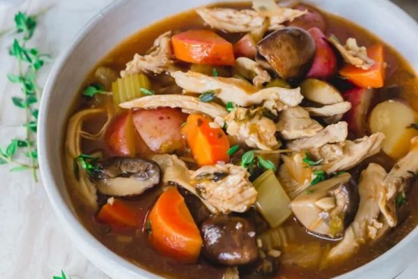 A hearty Turkey stew in a white bowl. 