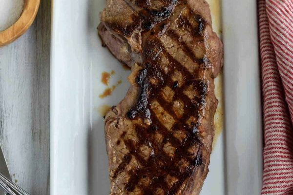 Tender london broil on a white plate.