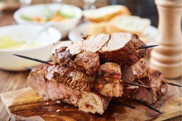 Texas Style Pork Loin served on a wooden chopping board.