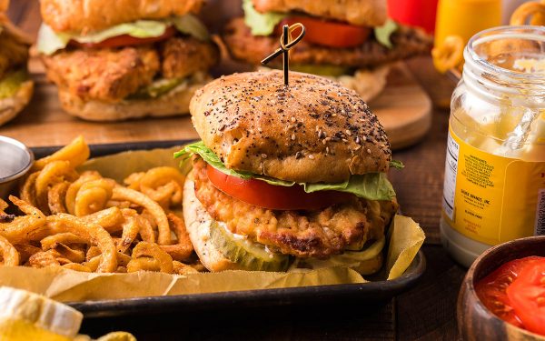 Fried chicken sandwich with french fries on the side.