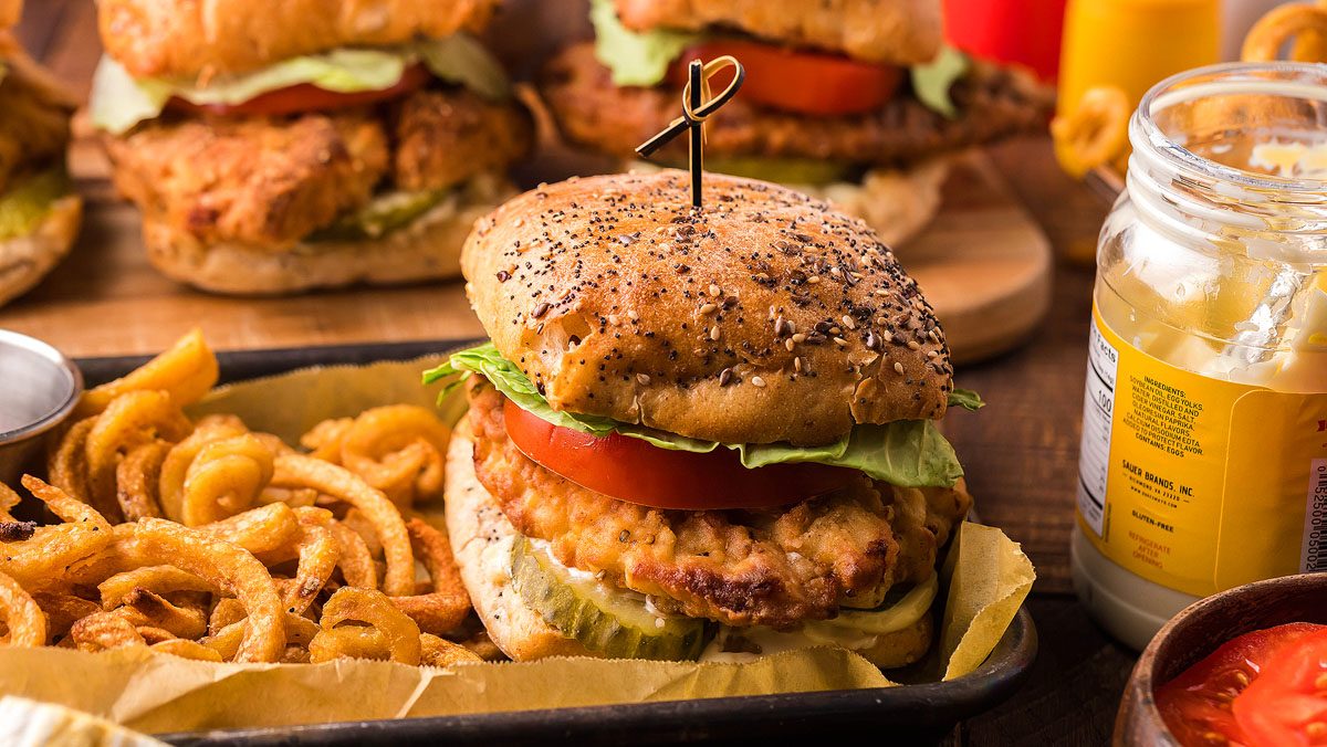Fried chicken sandwich with french fries on the side.