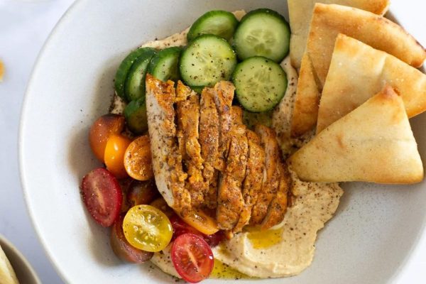 Chicken shawarma in a bowl with cucumbers.