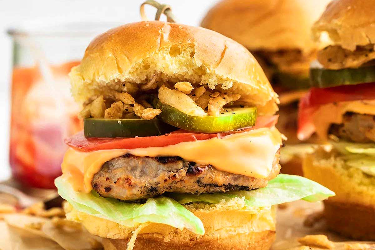 Turkey patties and toppings on sliders.