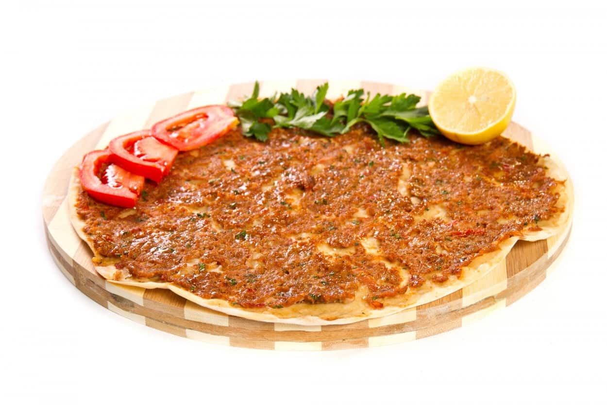 Turkey’s Lahmacun on a wooden board.