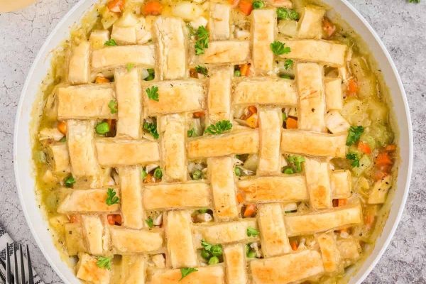 Turkey Pot Pie with Puff Pastry and a lattice in a round dish. 