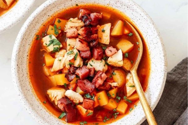 A bowl filled with hearty leftover vegetable soup. 