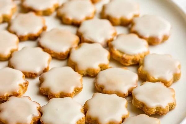 Almond flour cookies with frosting served on a plate.