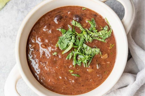Vegan black bean soup in a white bowl.