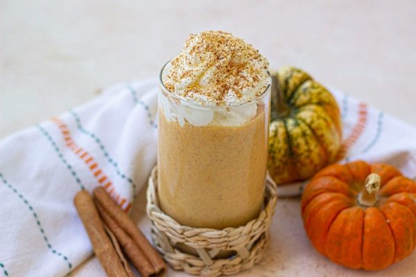 A pumpkin spice latte with cinnamon and whipped cream.