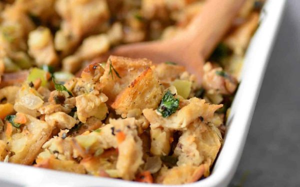 Vegan stuffing in a white casserole dish.