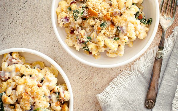 White cheddar mac and cheese in two white bowls.