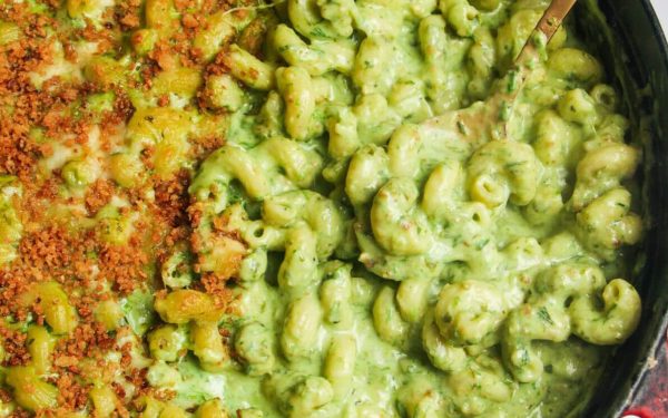 Mac and cheese with green sauce in a skillet. 