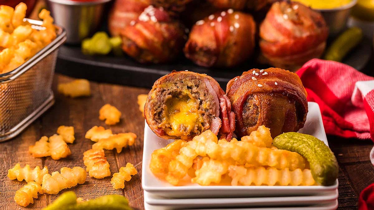 Cheeseburger bites on a plate with fries.