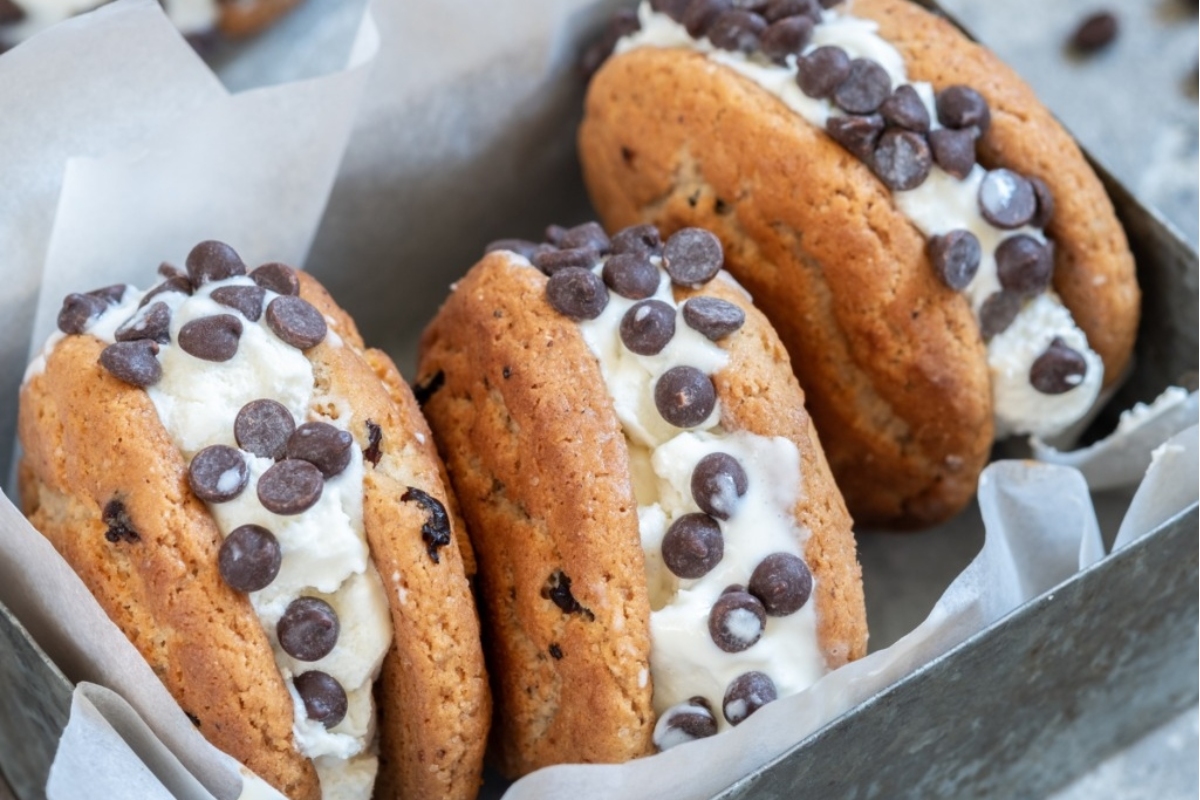 Chocolate chip ice cream sandwich with colorful candies in the cookies.