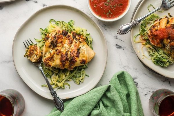 Hassleback chicken on two plates.