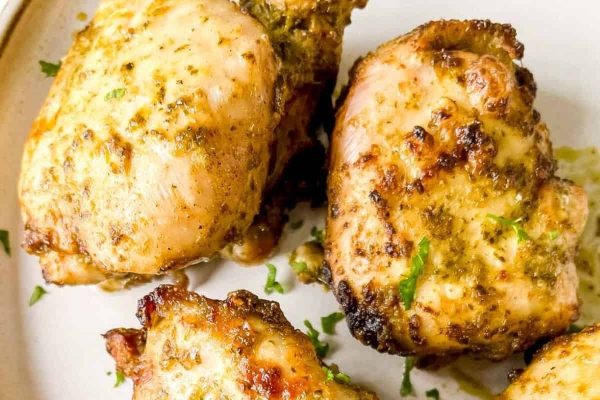 Air fryer pesto chicken on a white plate.
