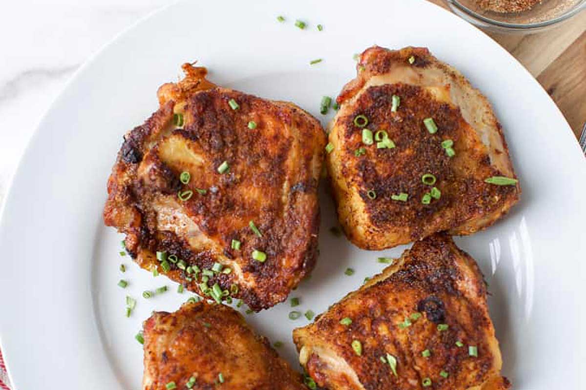 Chicken thighs on a plate.