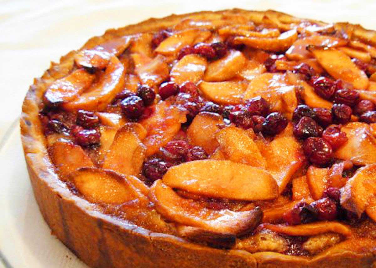 Homemade tart topped with apples and cranberries.