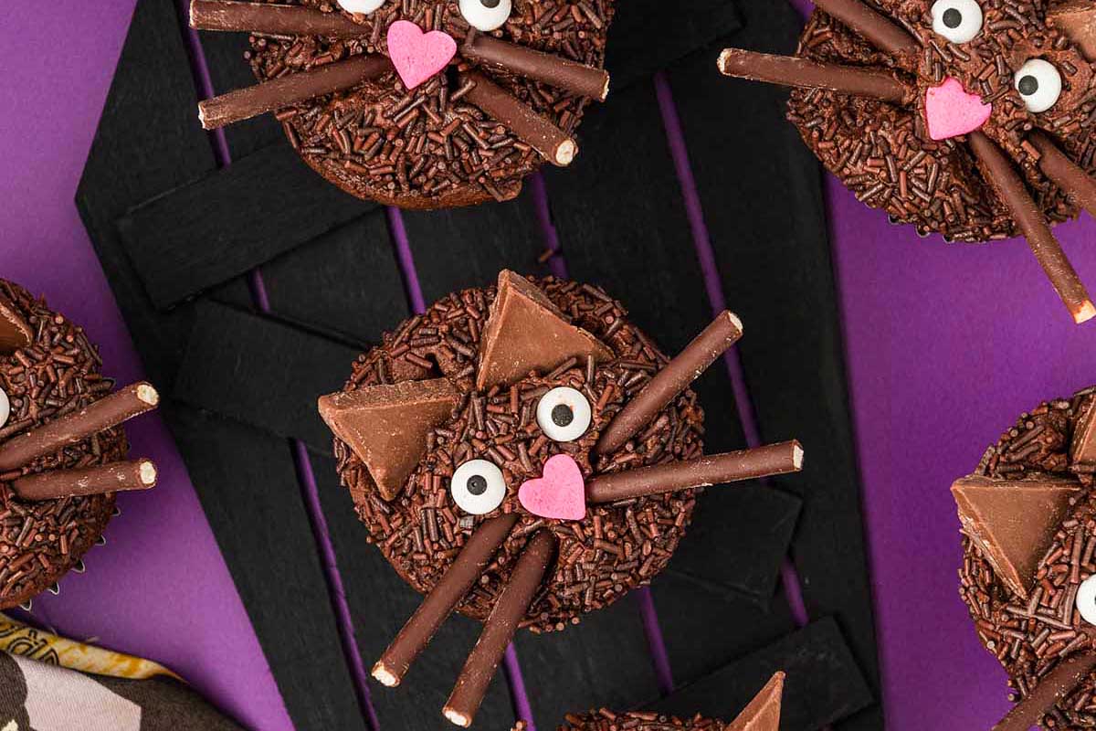 Black Cat Cupcakes on a purple table cloth.