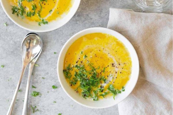 Two bowls of butternut squash soup.