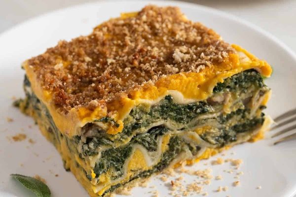One slice of squash lasagna on a plate.