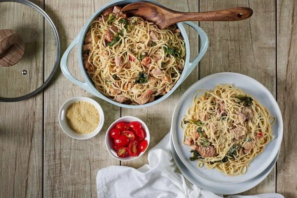 Cajun smoked turkey pasta with kale & andouille sausage on a plate. 