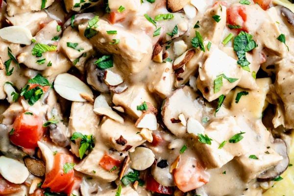 Chicken a la king with almond slices on top.