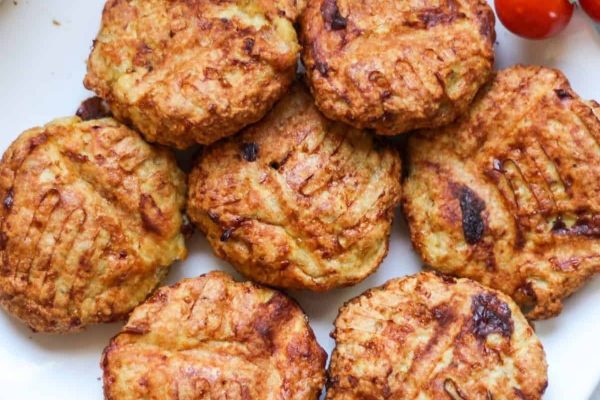 Chicken patties on a tray.