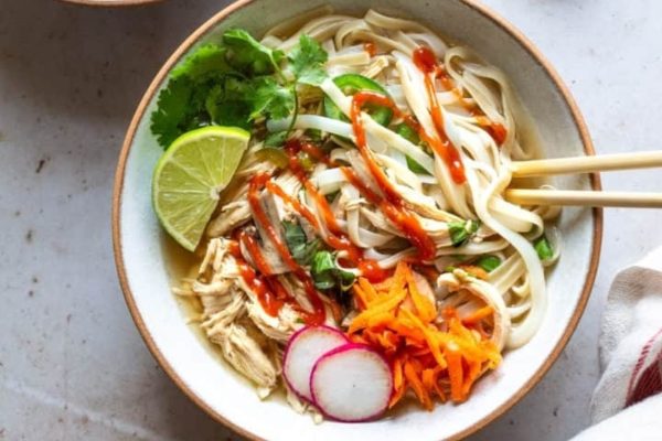 Bowl of noodles with chicken and vegetables.