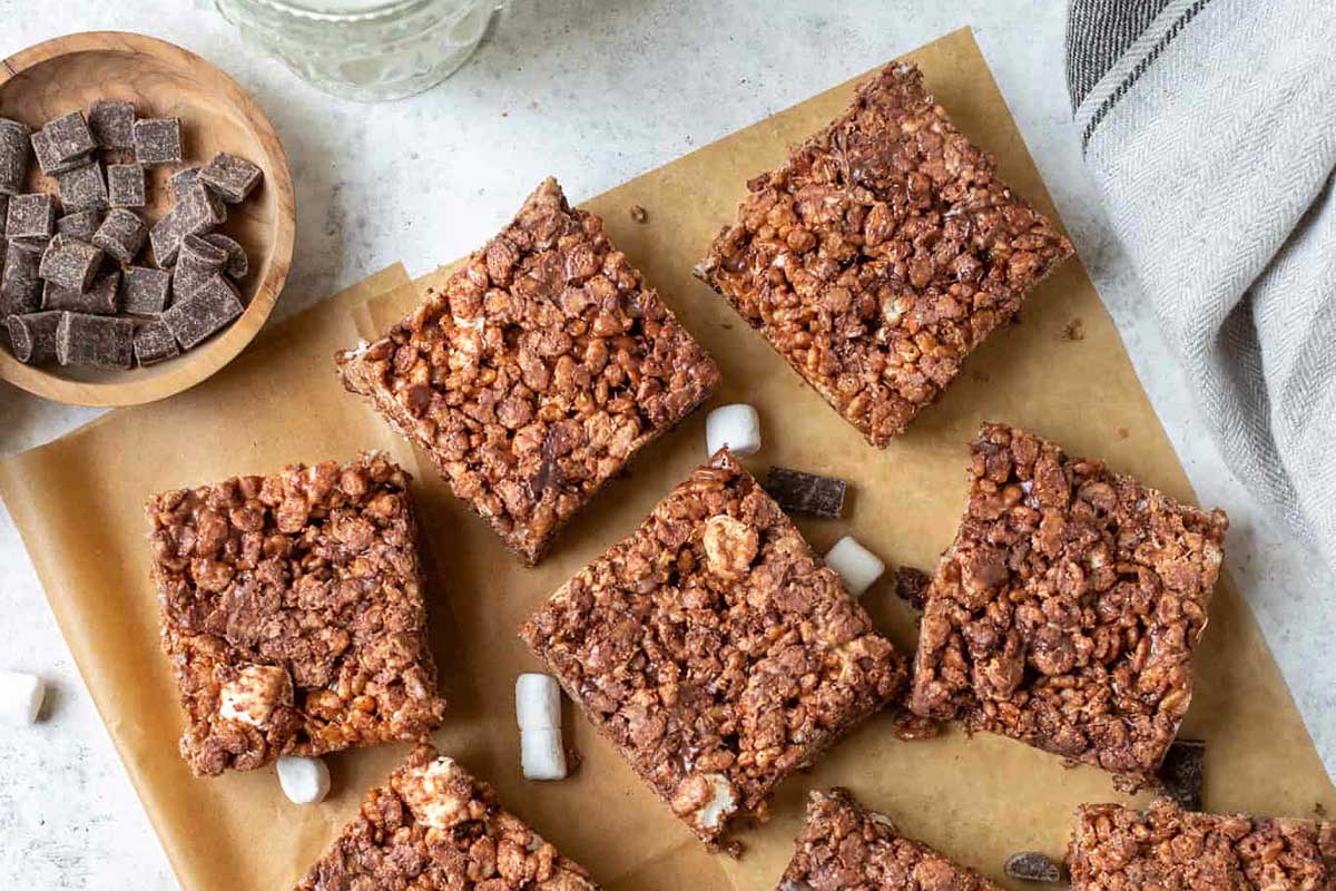 Caramel rice krispie treats cut on parchment paper.