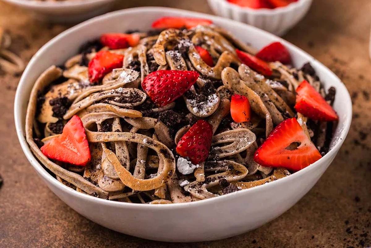 Chocolate pancake spaghetti in a white bowl.