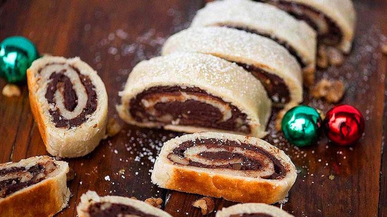 Italian chocolate cinnamon rolls on a wooden cutting board.