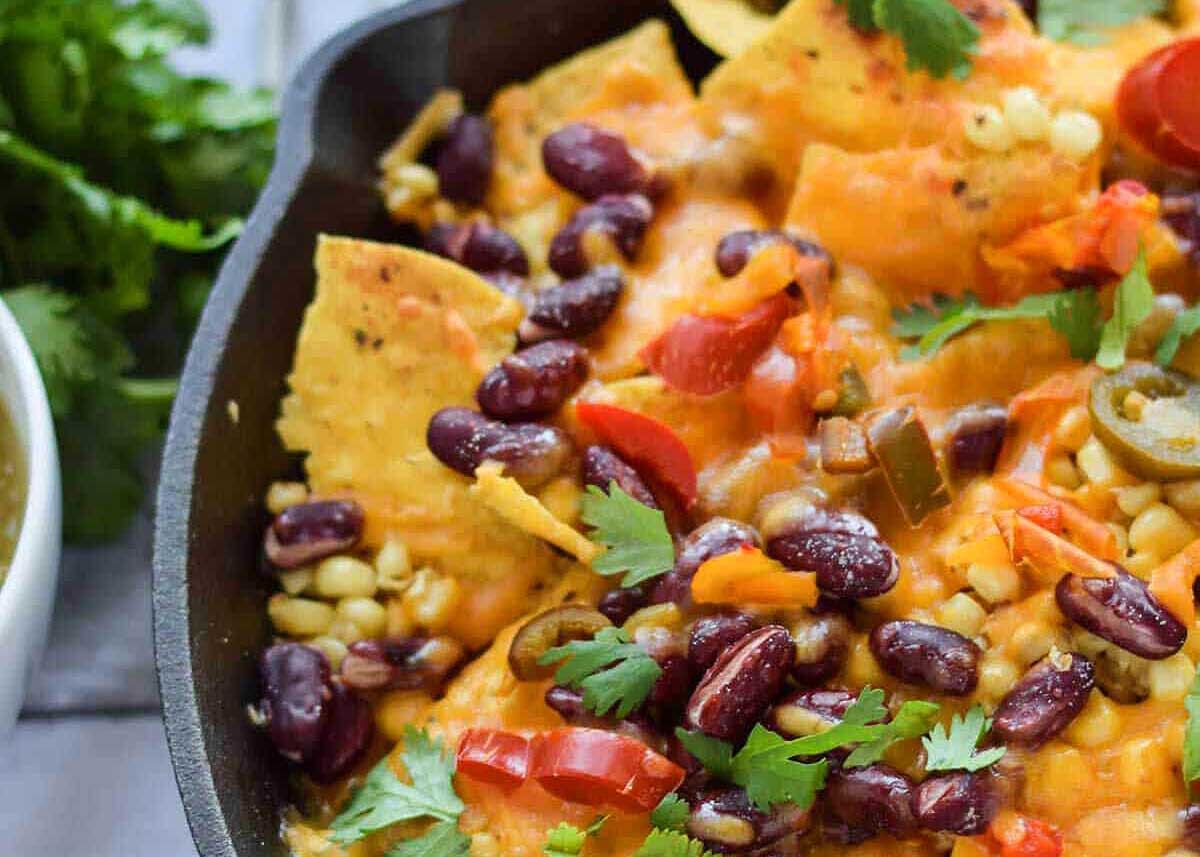 A skillet with nachos baked in it.