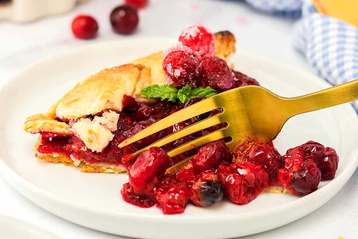 Rustic Cranberry Galette slice with fork taking piece.