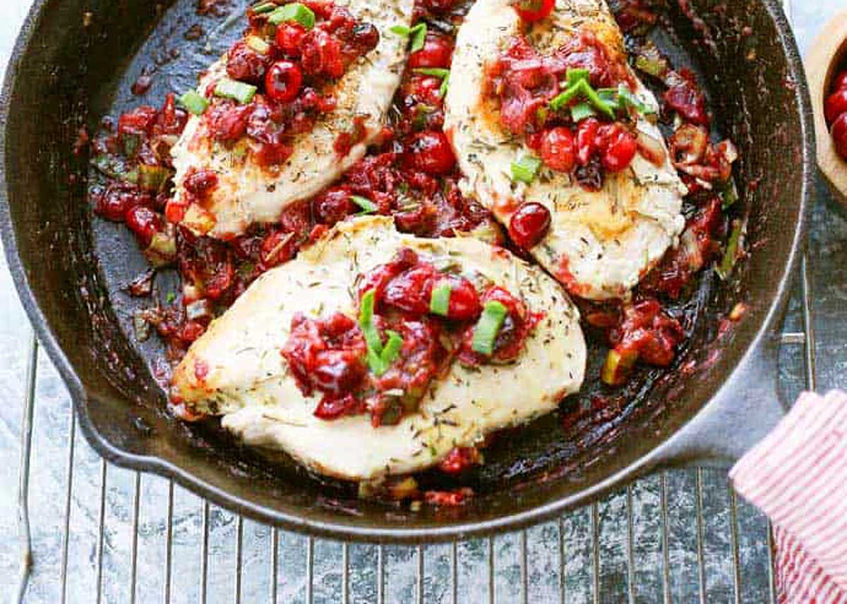 Chicken with cranberries and leek on top.