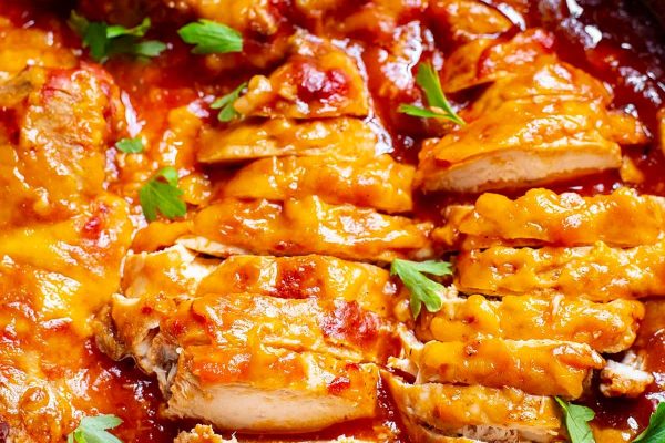 Crockpot salsa chicken sliced on a plate.