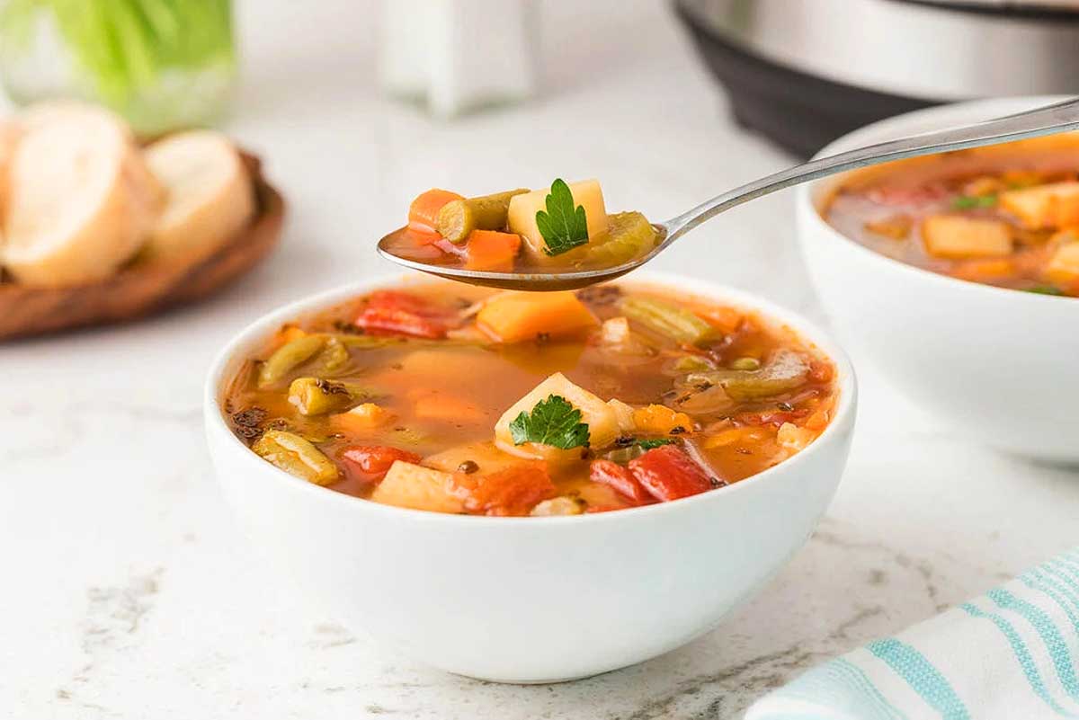 Two bowls of soup in front of an instant pot.