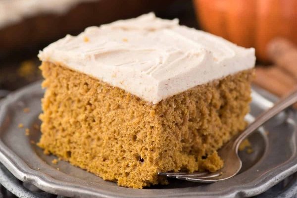 Slice of pumpkin cake on a gray plate.